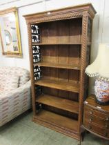 An Indonesian hardwood bookcase with metal elephant design to sides