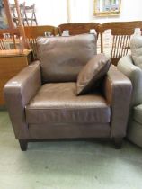 A brown leather upholstered chair with cushion