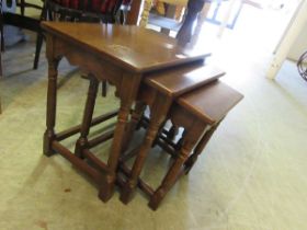A nest of three oak occasional tables