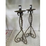 A pair of metal chainwork candlesticks