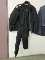 A black motorcycle suit comprising of jacket and trousers