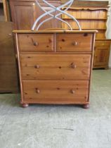 A modern pine chest of two short over two long drawers