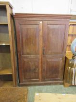 An early 20th century oak two door cupboard with shelving
