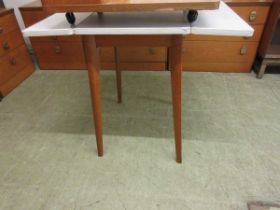 A mid-20th century Formica topped drop leaf table