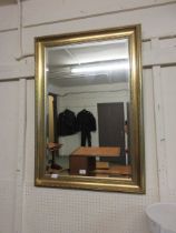 A reproduction gilt framed bevel glass mirror