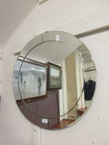 A circular glass wall mirror