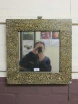 A square marble effect wall mirror