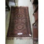 A brown eastern rectangular rug