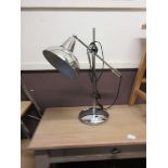 A modern chrome desktop reading lamp