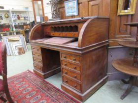 A 19th century mahogany veneered cylindrical topped twin pedestal desk