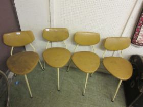 A set of four mid-20th century three legged machinist's chairs