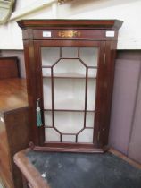 A reproduction mahogany wall mounted glazed door corner cabinet