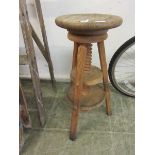 A pine circular adjustable stool