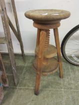 A pine circular adjustable stool