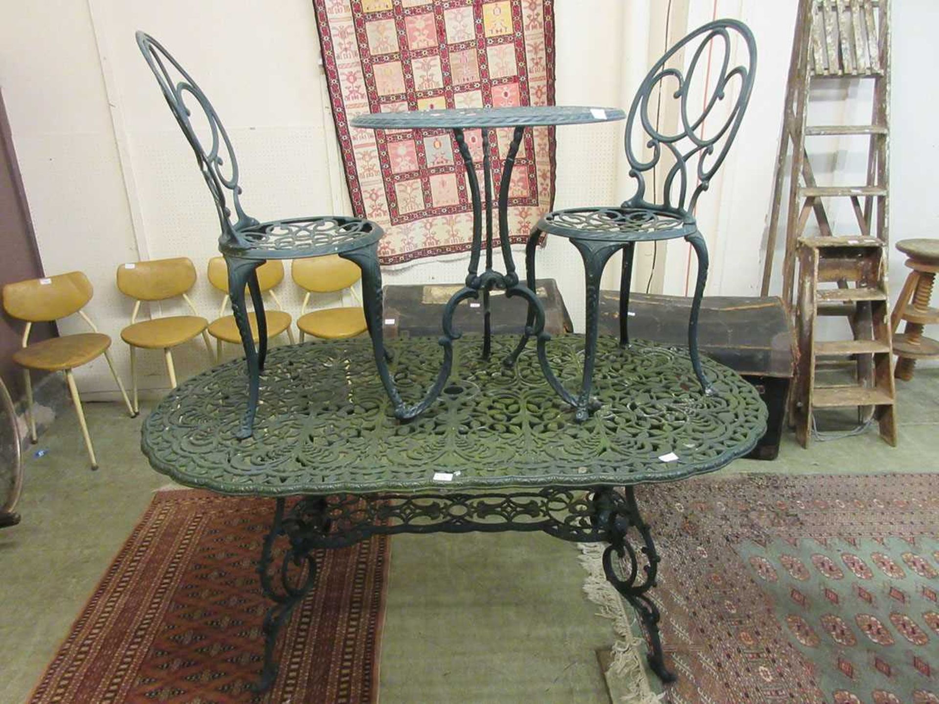 A green painted aluminium garden table together with a green painted aluminium bistro table and a