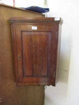 An Edwardian mahogany wall mounted corner cupboard