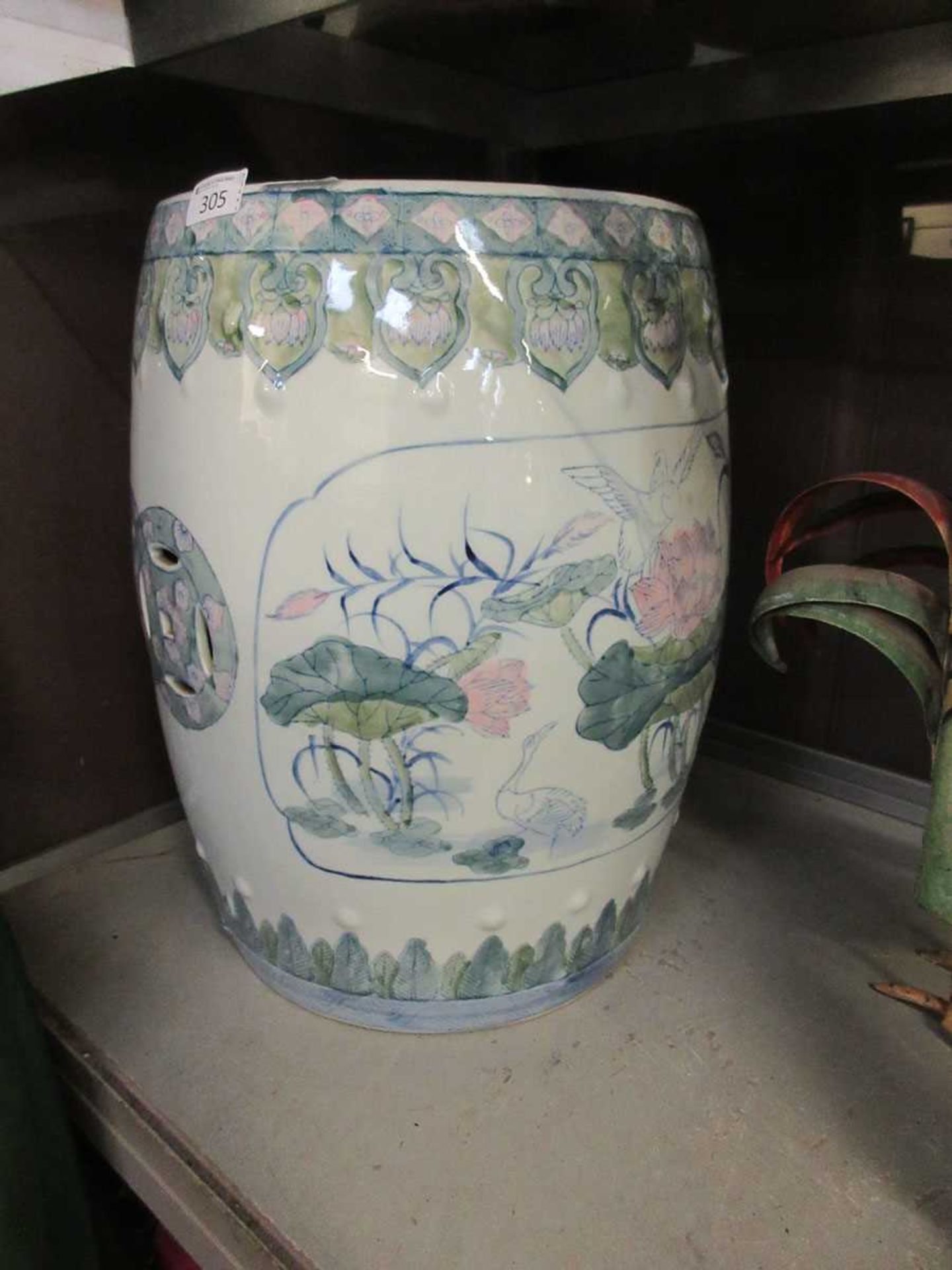 A white ground oriental style ceramic garden seat with bird on branch design