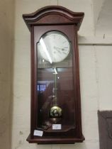 A reproduction mahogany drop dial wall clock