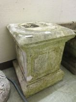 A weathered stone plinth