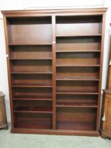 A substantial reproduction mahogany effect twin bookcase