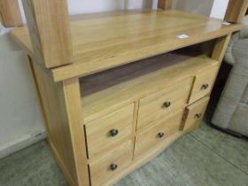 A modern corner oak TV stand having six more drawers to base