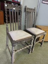 A pair of early 20th century oak framed dining chairs with barley twist design to back and front