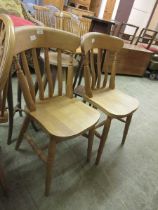 A pair of modern spindle back dining chairs