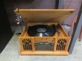 A modern cased turntable with AM/FM radio, CD and cassette player