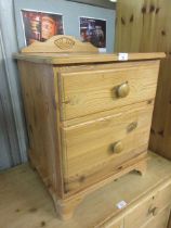A modern pine two drawer bedside chest