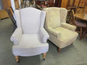 A modern high back winged arm chair upholstered in a yellow fabric together with one other modern