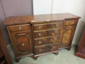 A small reproduction flamed mahogany effect sideboard having four drawers being flanked by