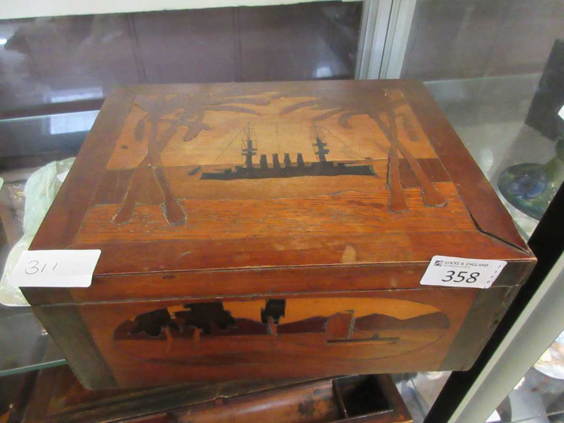 An early 20th century marquetry box with lid depicting a battleship