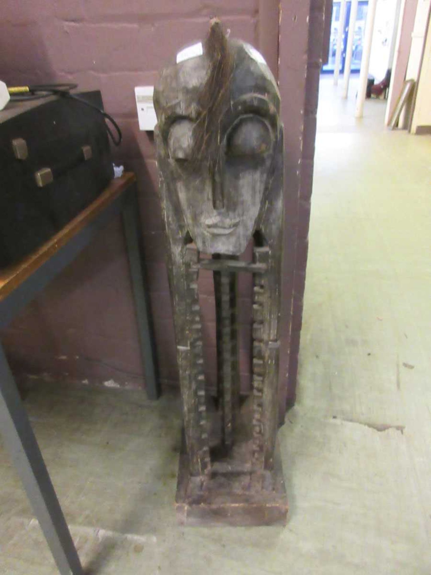 An African style carved wood CD/DVD rack, height approx. 1metre