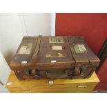 An early 20th century leather travelling trunk with brass locking clasps, 71cm wide