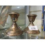 A pair of Sterling silver dressing table candlesticks assayed for Birmingham