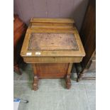 A Victorian walnut and cross banded Davenport with tooled leather writing surface (A/F)