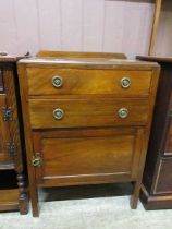 An early 20th century tall boy with two drawers over cupboard door, 66cm wide