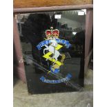 Foil backed image of insignia of the Royal Electrical and Mechanical engineers