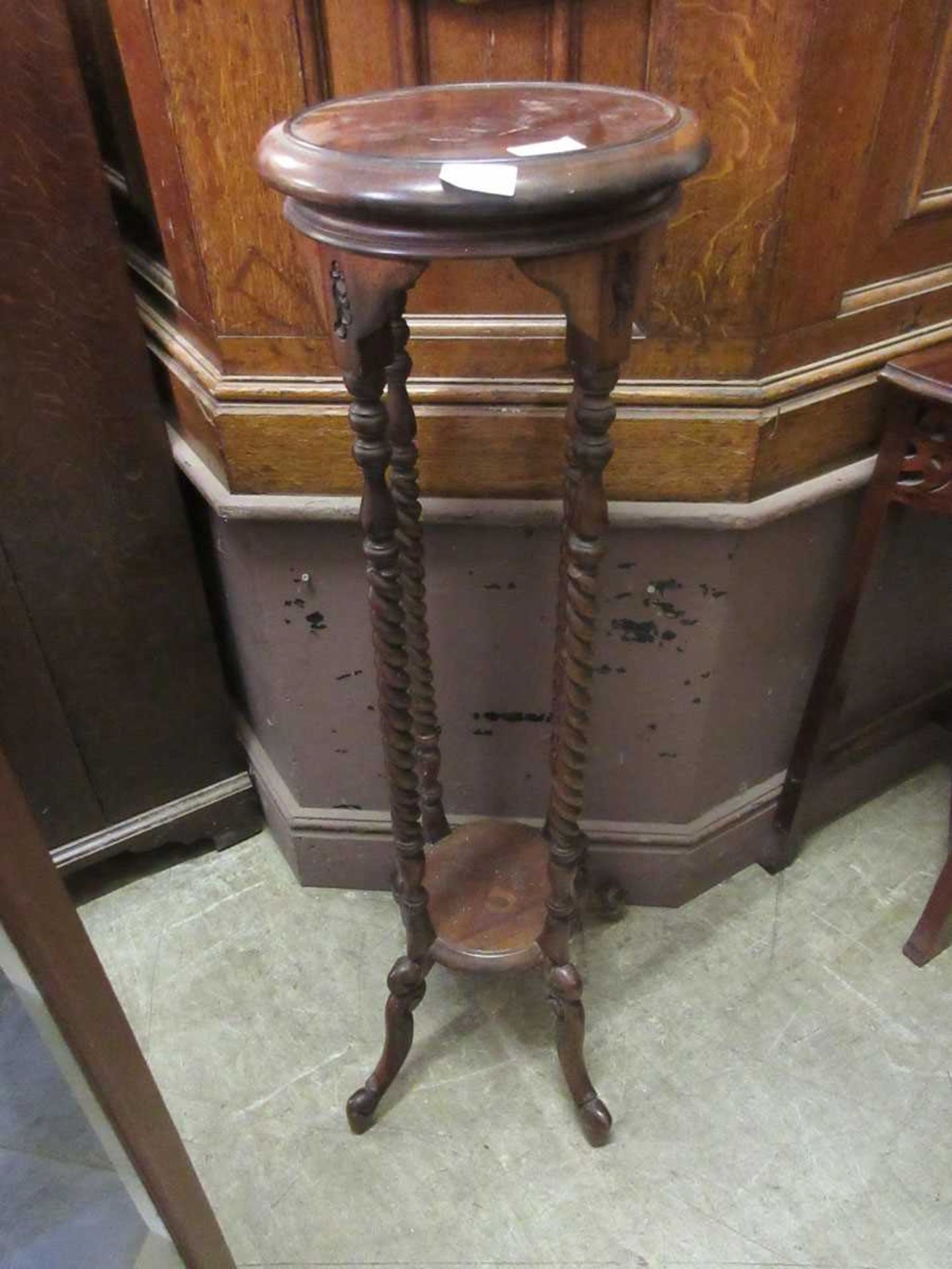 A reproduction jardiniere stand on barley twist supports, 101cm tall