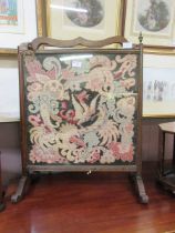 An early 20th century fire screen with tapestry panel depicting dragon