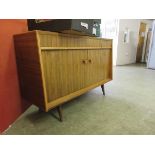 An Everest mid-20th century sideboard with helix pattern doors, on short feet, width; 137cm