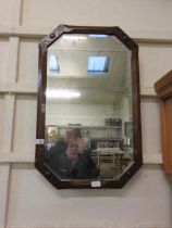 An octagonal oak framed bevel glass wall mirror