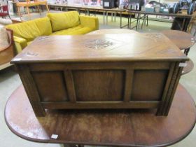 An oak and ply blanket box with floral carving to lid