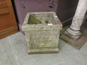 A square composite stone garden pot with embossed decoration