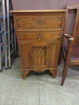 An oak media cabinet, the single drawer over cupboard door on bracket feet