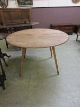 A mid-20th century light Ercol drop leaf kitchen table