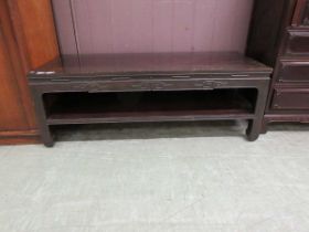 An oriental style stained wood coffee table
