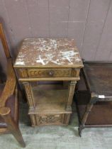 A heavily carved oak and marble side table with single drawer over under tier with cupboard door