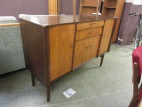 A mid-20th century style teak and veneered sideboard, two drawers above cupboard door flanked by