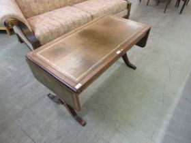 A reproduction walnut veneered occasional sofa table with tooled leather inset to top